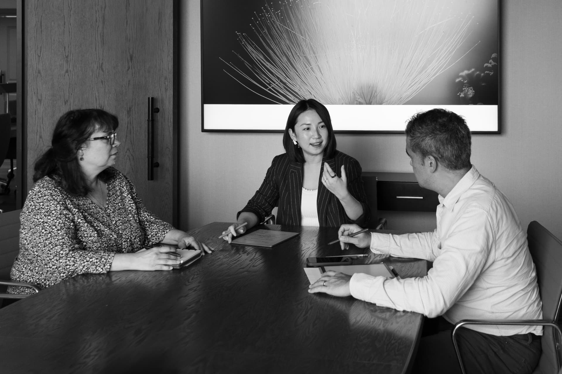 NuHo Capital team members in conversation around a conference table